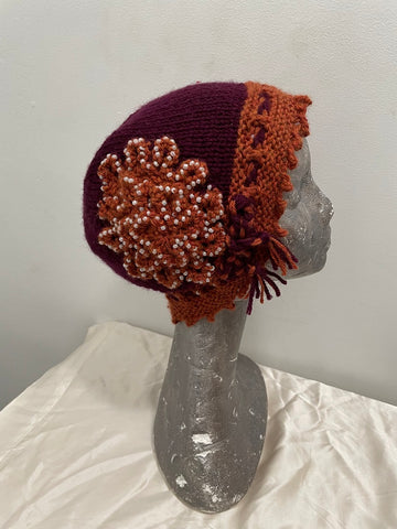 Knitted maroon and gold cloche hat with seed beads and rosette