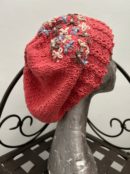 Knitted cotton and silk beanie in coral with embroidered flowers