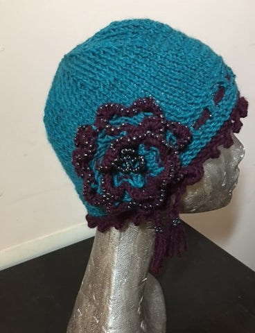 Knitted Pacific blue cloche hat with seed beads and rosette