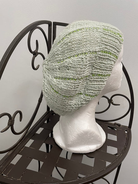 Knitted cotton and silk beanie in lime green with green glass seed beads