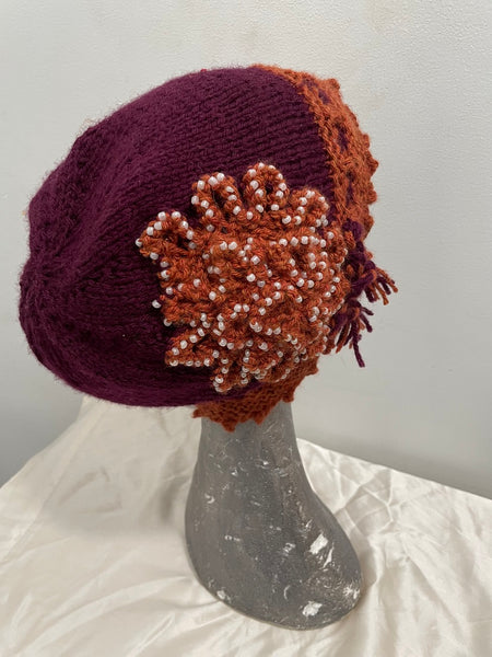 Knitted maroon and gold cloche hat with seed beads and rosette