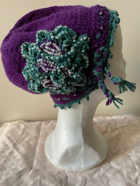 Purple knitted cloche with pearl seed bead trim