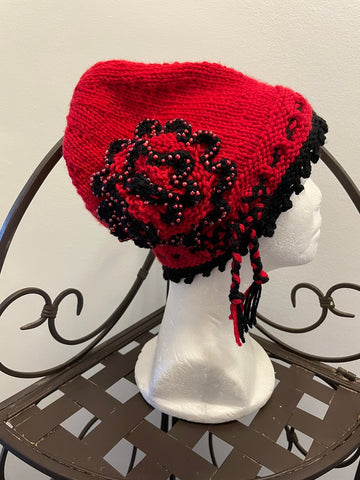Knitted red cloche hat with seed beads and rosette