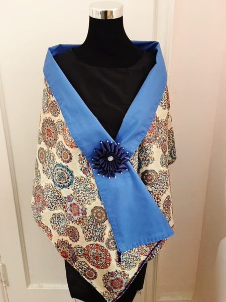 Medallion shawl with navy blue flower brooch